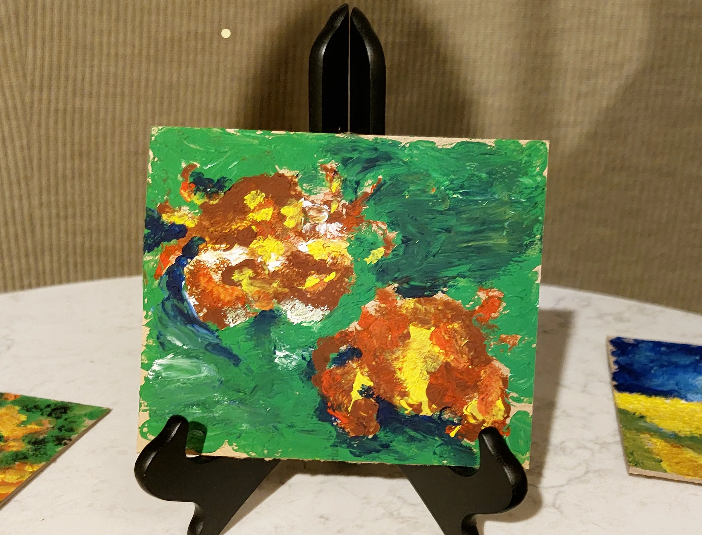 Whimsical painting of orange crabs on vivid green background with impasto texture